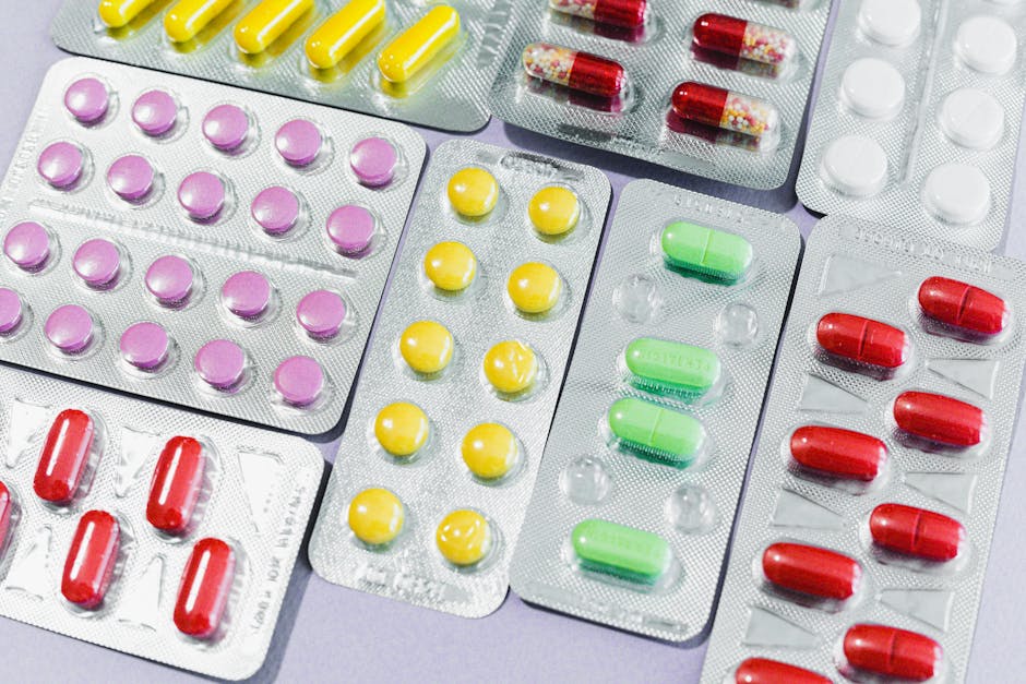 A variety of colorful pills and tablets in blister packs, representing diverse medication types.