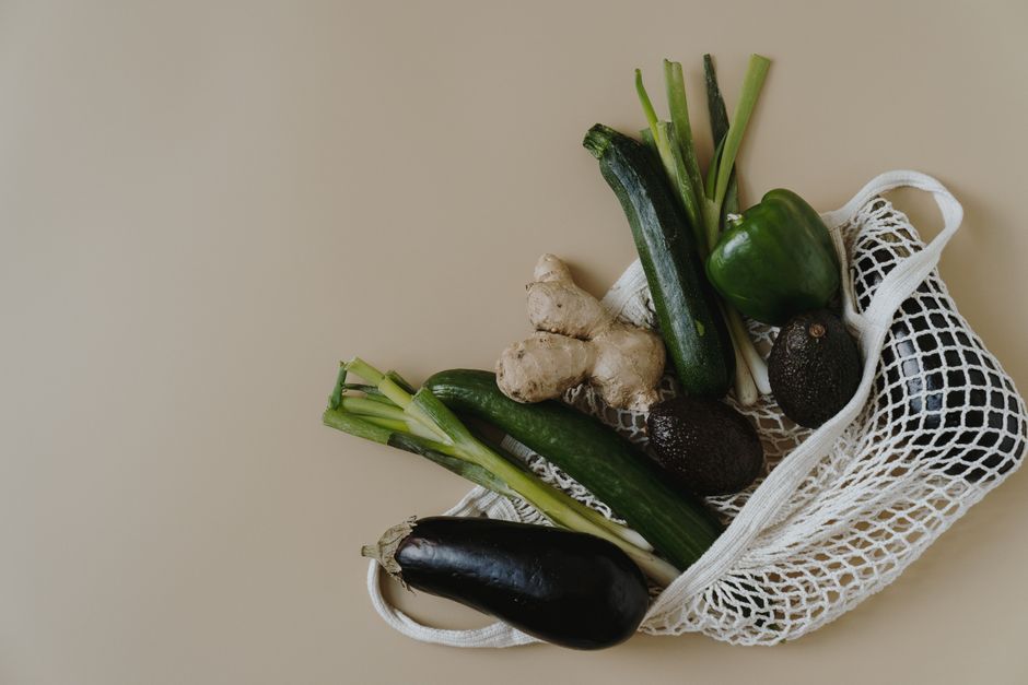 A variety of vegetables in a mesh bag highlighting healthy and zero waste shopping.