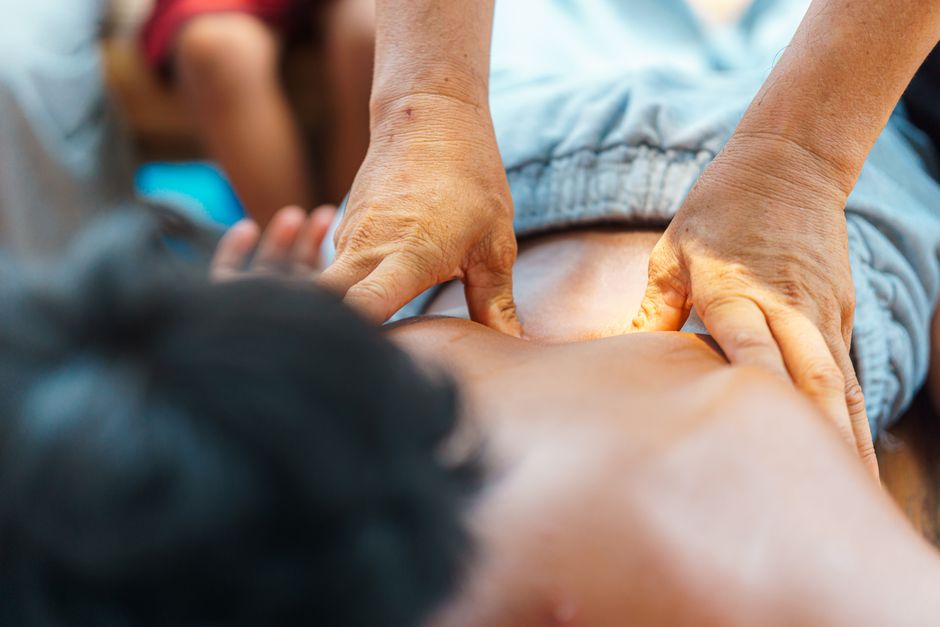 An outdoor therapeutic massage focused on the back, offering relaxation and tension relief.