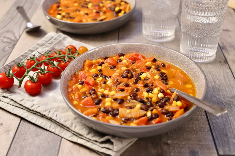 Warm and hearty vegetable bean stew served in rustic bowls, perfect for a cozy meal.