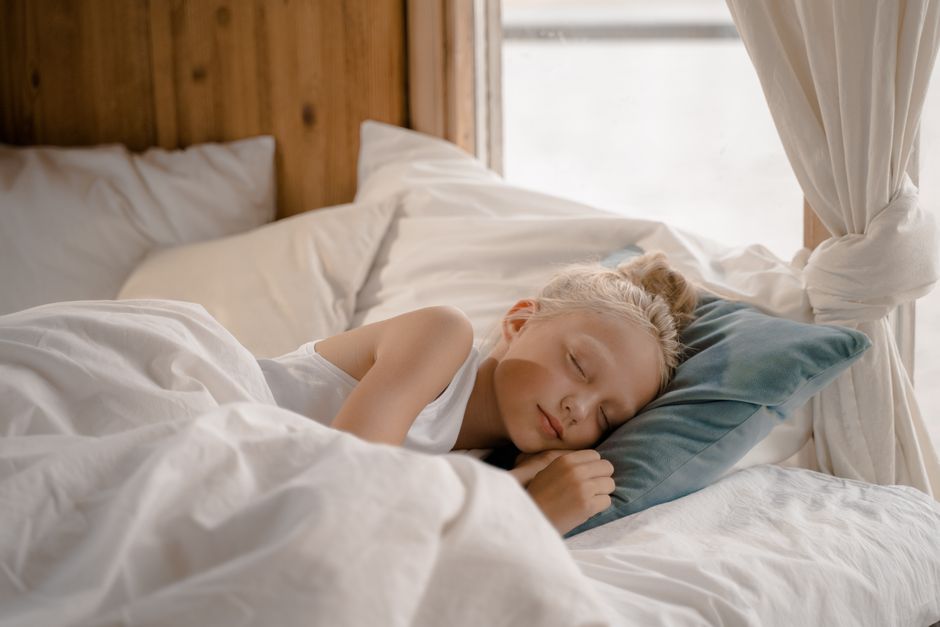 A serene image of a child sleeping peacefully in a cozy, modern bedroom.